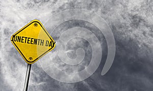 Juneteenth Day - yellow sign with cloudy background photo