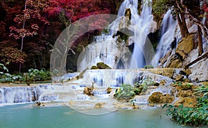 The jungle with Atumn trees fall as a waterfall-river-rocks-covered-with rainy forest-Waterfall in the forest at park