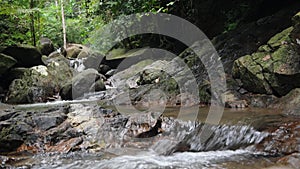 Jungle paradise landscape of tropical country. Waterfall cascade in green rain forest. Motion of water flow from cliff