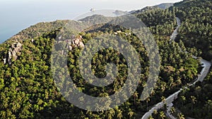 Jungles and mountains of tropical island. Drone view of green jungles and huge boulders on volcanic rocky terrain of Koh Tao