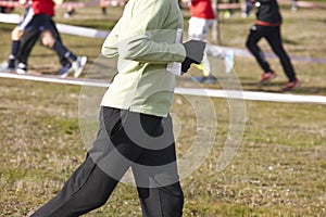 Junior athletic runner on a cross country race. Outdoor circuit