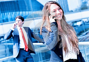 Junior executive dynamic phoning outside of her office