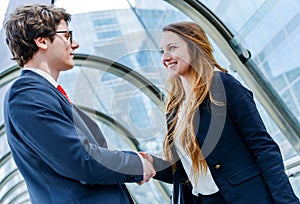 Junior executives dynamics shaking hands