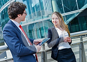 Junior executives having a coffee break in front of their company