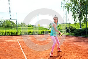 Junior girl practicing a backhand stroke