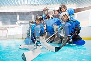 Junior hockey team with goalie on ice rink