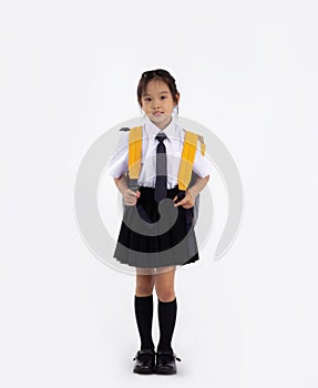 Junior school student in uniform with yellow backpack. Back to school