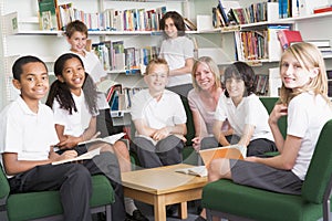 Junior school students working in a library photo