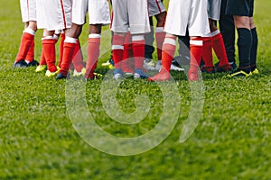 Junior Soccer Team Standing in Group. Football Grass Field and Players Feet. Soccer Stadium Grass Background