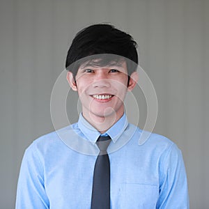 Junior young good looking Asain businessman in shirt and necktie pose with smile face and friendly positive gesture