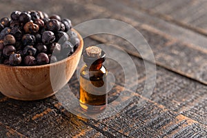 Juniper Berry Essential Oil on a Distressed Wooden Table