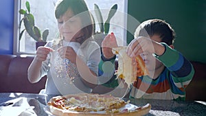 Junk eating, sister with brother eat fast food during lunch in cafe near window