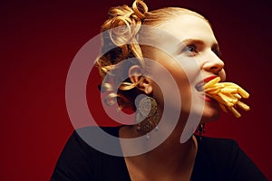 Junk food concept. Girl eating fries