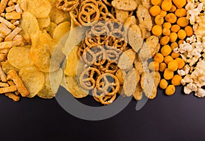 Junk food. A lot of junk food on a black background. Copy space.
