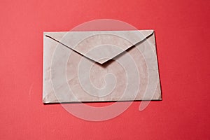 Junk mail or spam and fake letter idea. Concept for unsolicited mail or e-mail. Envelope on red background photo