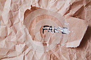 Junk mail or spam and fake letter idea. Concept for unsolicited mail or e-mail. The word fake on a piece of paper.