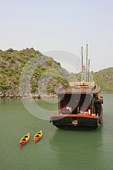Junk towing kayaks, Halong Bay, Vietnam