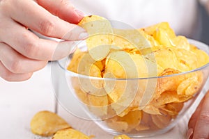 Junk unhealthy food, heap of potato chipa in big dish