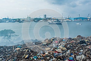 Junk yard lanscape view full of smoke, litter, plastic bottles,rubbish and trash at the Thilafushi local tropical island