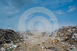 Junk yard view full of smoke, litter, plastic bottles,rubbish and trash at the Thilafushi local tropical island