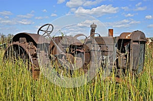 Junked tractor lacking parts and tires