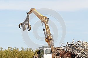 Junkyard crane with maginet moving scrap recycled steel