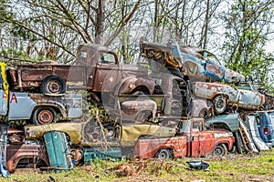 Junkyard pile up of old vintage vehicles
