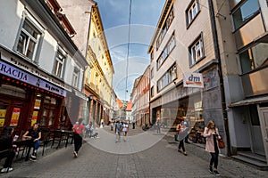 Jurciceva Ulica street with people passing by boutiques and shops in Maribor.