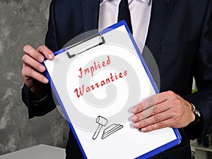 Juridical concept meaning Implied Warranties with sign on the page