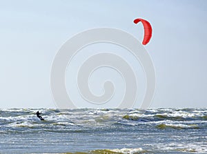 Jurmala Latvia. Surfing at the sea with a red parachute at s