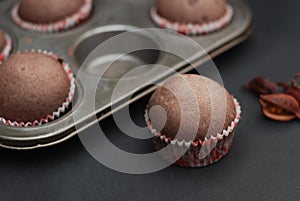 Just Baked Homebaked Chocolate Muffins for Dessert with colored Conffeti. Dark Background.