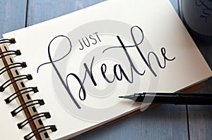 JUST BREATHE hand-lettered in notepad