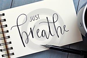 JUST BREATHE hand-lettered in notepad with brush pen