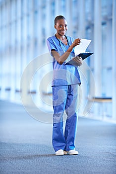 Just checking the charts. Portrait of a young female doctor holding a patients chart.