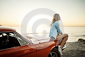 Just chilled vibes. a young woman enjoying a road trip along the coast.