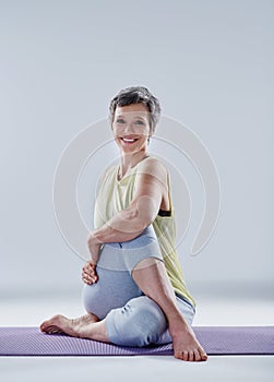 Just a few more stretches. Full length portrait of an attractive woman stretching before yoga.