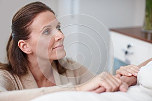 Just the friendly face youd want in a hospital. An affectionate daughter visiting a sick relative in the hospital.