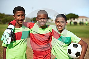 Just give us a ball and well be happy. Portrait of a group of young boys playing soccer on a sports field.