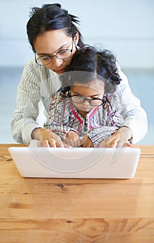 Just going through my emails. A little girl pretending to work on the computer.