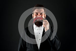 Just have fun. Ruthless and strong in business. cheerful businessman has funny red pepper moustache. barbershop concept