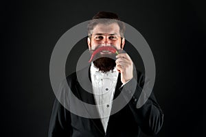 Just have fun. Ruthless and strong in business. cheerful businessman has funny red pepper moustache. barbershop concept photo