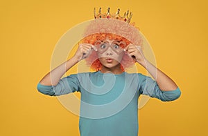 just having fun. fancy party look. egocentric kid in clown wig and crown.