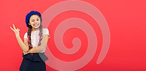 Just having fun. Summer holidays. Kid little cute fashion girl posing with long braids and hat red background. Child