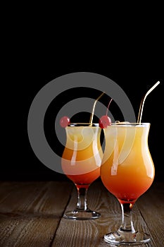 Just made appetizing cocktails Sex on the Beach, black background. Space for