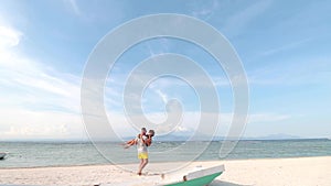 Just married couple having fun at the beach of tropical island Nusa Lembongan, Indonesia. Asia. The volcano Agung on the