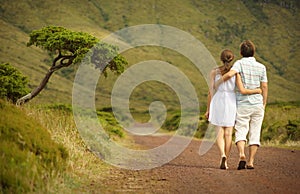 Just married couple in honneymoon walking along countriside road on Flores island, Azores photo