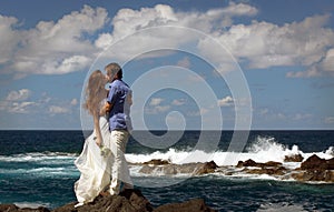 Just married couple kissing on ocean shore on Flores island, Azores