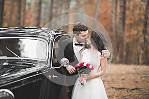 Just married couple in the luxury retro car on their wedding day