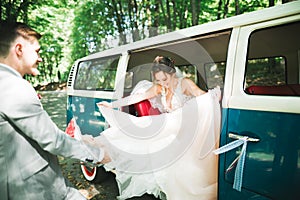 Just married couple in the luxury retro car on their wedding day