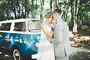 Just married couple in the luxury retro car on their wedding day